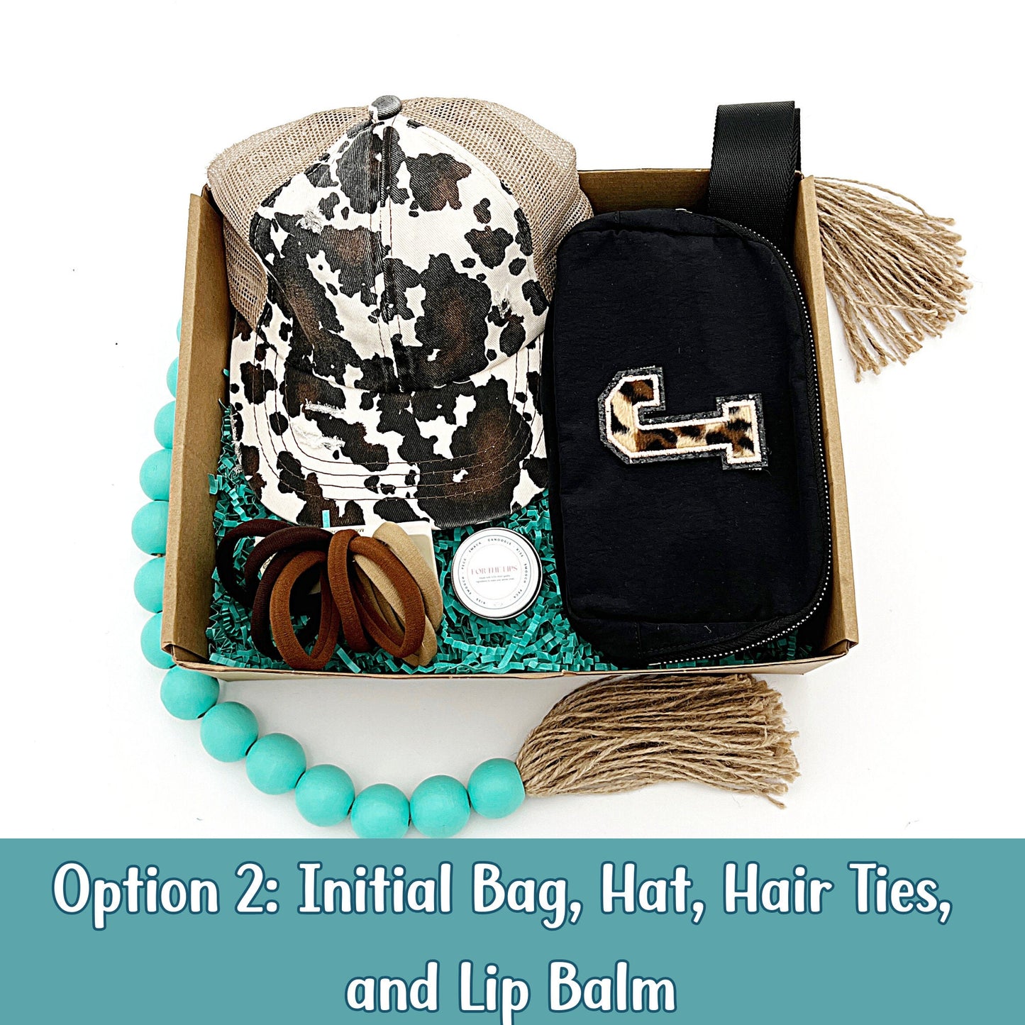 Gift box for her with a cow print hat, personalized fanny pack, hair ties, and lip balm.
