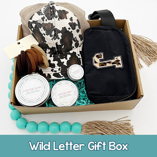 Leopard and cow print themed gift box includes a personalized fanny pack, Camo leopard print hat, hair ties, candle, lotion bar, and lip balm