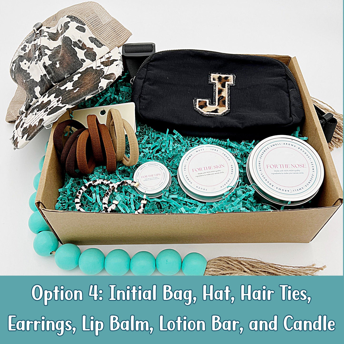 Deluxe personalized gift box with a camo print hat, custom initial waist bag, hair tie, earrings, candle, lotion, and lip balm.